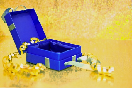 beautiful present box on golden shining surfaceの写真素材