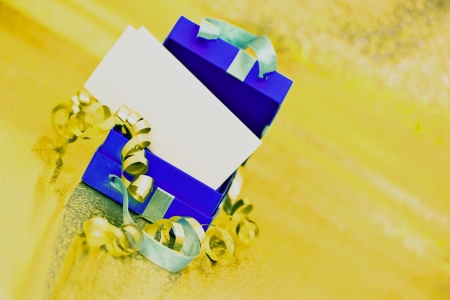 beautiful present box on golden shining surfaceの写真素材