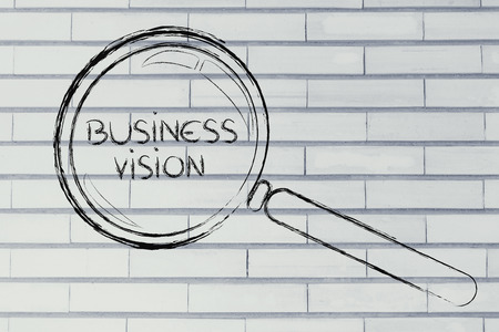 magnifying glass focusing on business vision and managementの写真素材