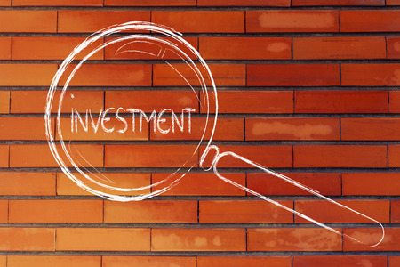 magnifying glass seeking good investmentの写真素材