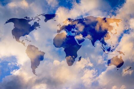 semi transparent glowing overlay creating the map of the world above the skkyの写真素材