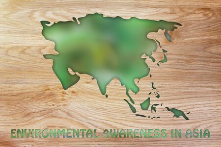 environmental awareness throughout the world: illustration with map of asia made of green leaves blurの写真素材