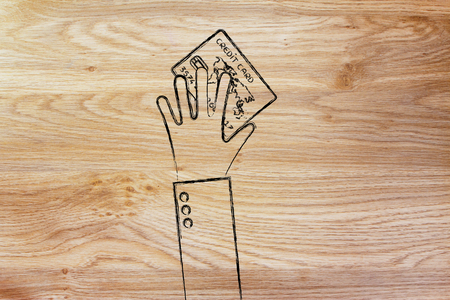 concept of saving & spending: hand holding credit cardの写真素材