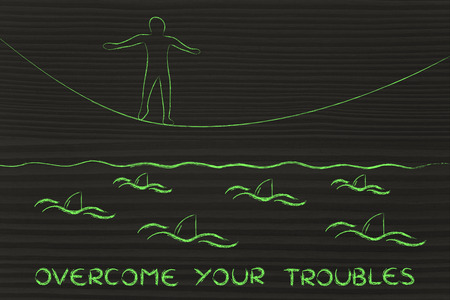 concept of overcoming your troubles: man on tightrope and sharks in the waterの写真素材