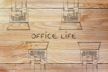 Office life concept: hands typing on laptops from the same deskの写真素材