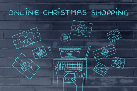 online Christmas shopping: hands typing on computer to place an order, surrounded by presentsの写真素材