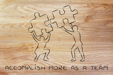 accomplish more as a team: people about to match two pieces of puzzle, metaphor of being close to a solutionの写真素材