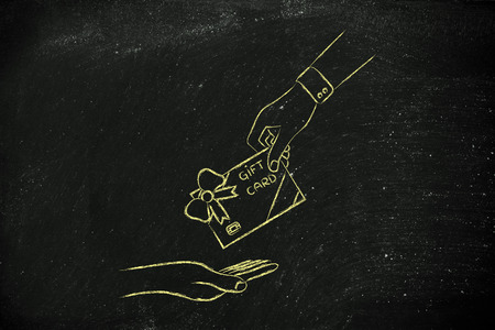 hand giving gift card with wrapping bow, concept of rewarding customersの写真素材