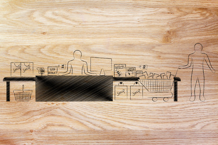 customer with shopping cart and products standing by a store's cashierの写真素材