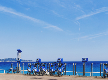 NICE, FRANCE - 06 May, 2016: The Promenade des Anglais seaside walk in Nice with the famous blue bikes, turquoise water and sunny weatherのeditorial素材
