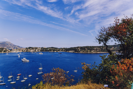 ViILLEFRENCHE-SUR-MER, FRANCE - 05 May, 2016: Villefranche seaside and coastline view from above the hillside, with deep blue water, serene sky and plenty of sailing boatsのeditorial素材