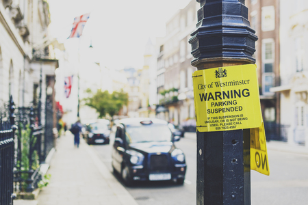 LONDON, UK - August 02, 2014: road sign in London with architecture an taxi cab bokeh in Mayfairのeditorial素材