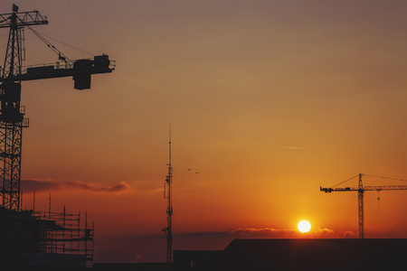 DUBLIN, IRELAND - 22st January, 2017: beautiful orange sunset among Dublin's many construction tower cranesのeditorial素材