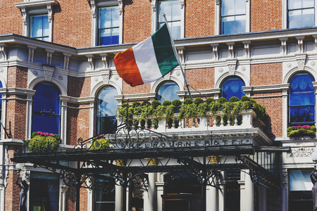DUBLIN, IRELAND - 10th June, 2017: detail of the Irish flag waving from the Shelbourne Hotel's entrance in Dublinのeditorial素材