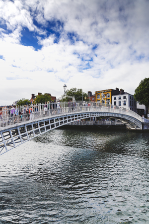 DUBLIN, IRELAND - July 15th , 2017: view of the historical Ha'Penny Bridge over the River Liffey in Dublin, Ireland (with unidentified people)のeditorial素材