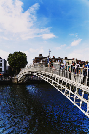 DUBLIN, IRELAND - July 15th , 2017: view of the historical Ha'Penny Bridge over the River Liffey in Dublin, Ireland (with unidentified people)のeditorial素材