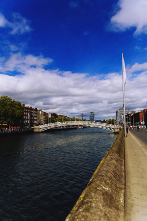 DUBLIN, IRELAND - July 15th , 2017: view of the historical Ha'Penny Bridge over the River Liffey in Dublin, Ireland (with unidentified people)のeditorial素材