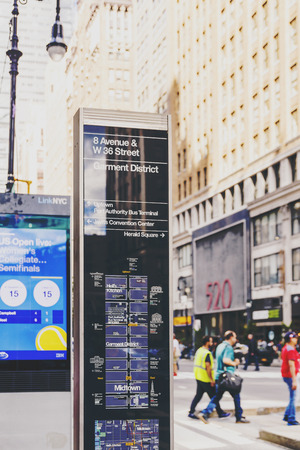 NEW YORK, NY - September 8th, 2017: Garment District street sign in Manhattan shot at shallow depth of field with building and crowd bokehのeditorial素材
