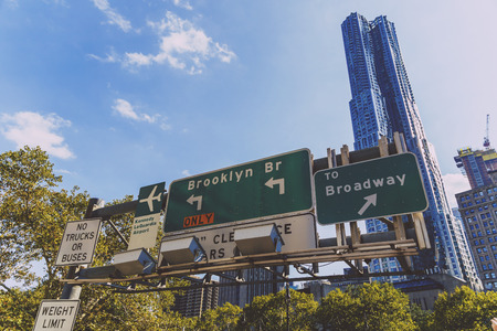 NEW YORK, NEW YORK - September 4th, 2017: Architecture and beautiful buildings along the streets of Manhattan New York in the City Hall area near Brooklyn Bridge with street sign, on a sunny late summer dayのeditorial素材