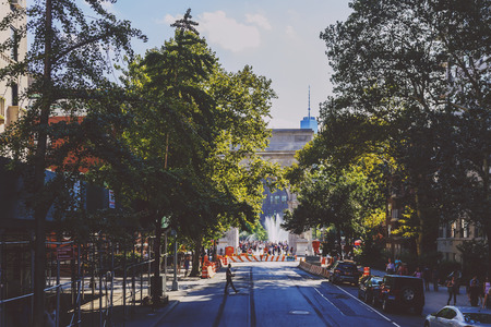 NEW YORK, NEW YORK - September 4th, 2017: Washington Square Park Arch in the distance seen from the Fifth Avenue in Manhattan New York on a sunny late summer day (with unidentified people)のeditorial素材