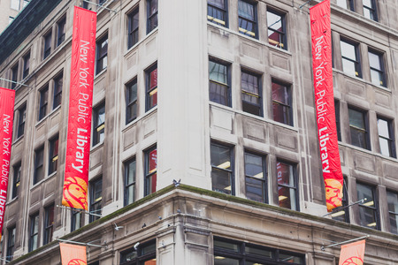 NEW YORK, NY - June 9th, 2014: detail of Manhattan building with New York Public Library bannersのeditorial素材