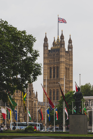 LONDON, UNITED KINGDOM - August, 13th, 2015: square with flags outside of the Big Ben and Westminsterのeditorial素材