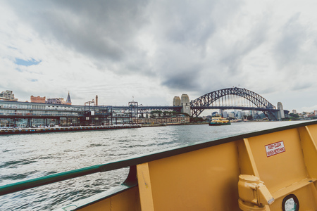 SYDNEY, AUSTRALIA - July 10th, 2013: Sydney Harbour Bridge shot during a ferry ride on an overcast...