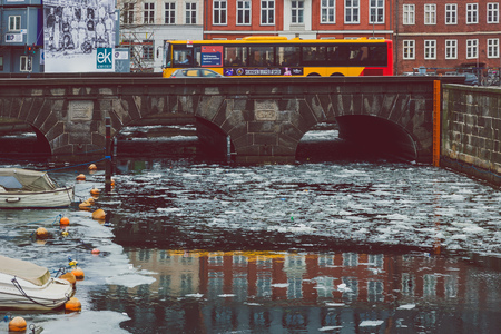 COPENHAGEN, DENMARK - March 11th, 2018: Architecture and buildings of the streets of Copenhagen featuring frozen canals with ice blocks in the waterのeditorial素材