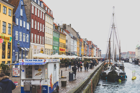 COPENHAGEN, DENMARK - March 11th, 2018: Copenhagen's famous Nyhavn harbour with the typical colorful houses and restaurants along the iced canals with traditional boatsのeditorial素材