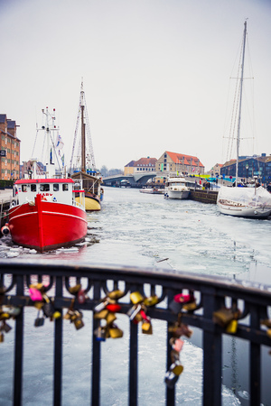 COPENHAGEN, DENMARK - March 11th, 2018: Copenhagen's famous Nyhavn harbour with the typical colorful houses and restaurants along the iced canals with traditional boatsのeditorial素材