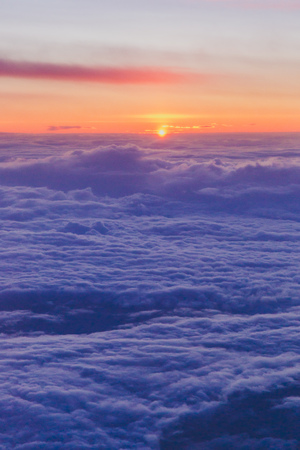sunset with pink and purple tones shot from airplane window seat of a commercial flightの写真素材
