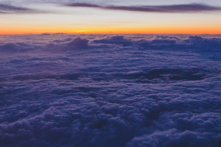 sunset with pink and purple tones shot from airplane window seat of a commercial flightの写真素材