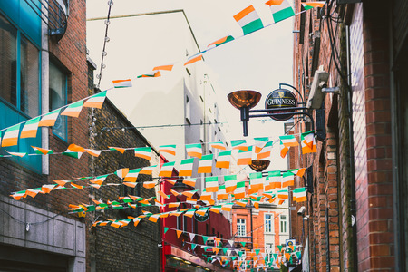 DUBLIN, IRELAND - 28th March, 2018: view of Dame Lane in Dublin city centre a traditional street with pubs and Irish flags all alongのeditorial素材