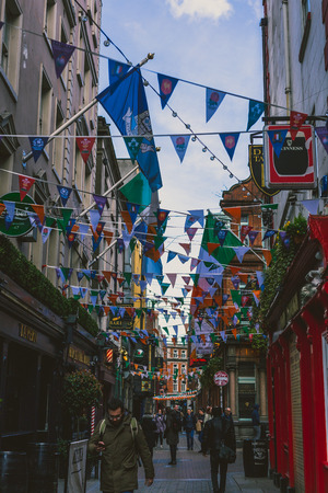 DUBLIN, IRELAND - 28th March, 2018: view of Dame Lane in Dublin city centre a traditional street with pubs and Irish flags all alongのeditorial素材