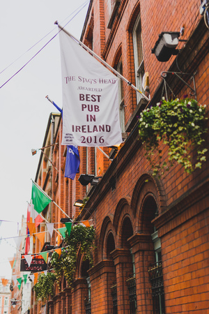 DUBLIN, IRELAND - 28th March, 2018: view of Dame Lane in Dublin city centre a traditional street with pubs and Irish flags all alongのeditorial素材