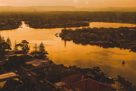 GOLD COAST, AUSTRALIA - January 6th, 2014: dramatic orange sunset over the coastline and buildings...