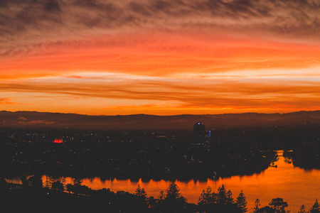 GOLD COAST, AUSTRALIA - January 6th, 2014: dramatic orange sunset over the coastline and buildings of Surfers Paradise in Gold Coastのeditorial素材