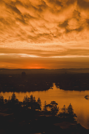 GOLD COAST, AUSTRALIA - January 6th, 2014: dramatic orange sunset over the coastline and buildings of Surfers Paradise in Gold Coastのeditorial素材
