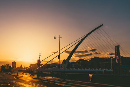 DUBLIN, IRELAND - April 30th, 2018: view of Dublin's famous Samuel Beckett Bridge over the river Liffey at sunsetのeditorial素材