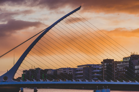 DUBLIN, IRELAND - May 9th, 2018: Majestic orange and pink toned sunset over the river Liffey in Dublin, featuring the Samuel Beckett bridgeのeditorial素材