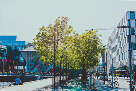DUBLIN, IRELAND - May 16th, 2018: detail of Grand Canal Square with trees, bikes and pedestrian on the affluent side of Dublin Docklandsのeditorial素材