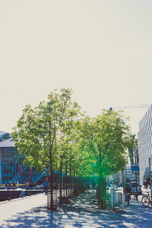 DUBLIN, IRELAND - May 16th, 2018: detail of Grand Canal Square with trees, bikes and pedestrian on the affluent side of Dublin Docklandsのeditorial素材