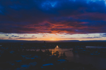 GOLD COAST, AUSTRALIA - January 15th, 2015: dramatic tropical sunset over Surfers Paradise with mountain viewのeditorial素材