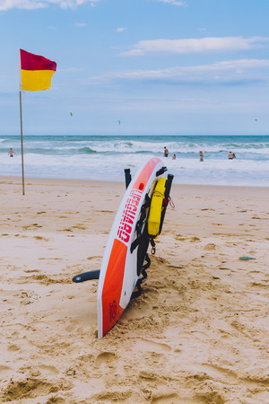 GOLD COAST, AUSTRALIA - January 14th, 2015: lifeguard surfboard and lifesaving flag on the beach in Surfers Paradiseのeditorial素材