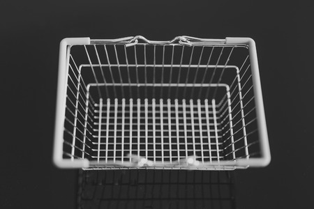 empty silver shopping basket on black seen from above shot at shallow depth of fieldの写真素材
