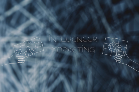 social media marketing conceptual illustration: influencer marketing text with PR gifts being handed at itの写真素材