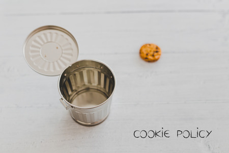 cookie going into a trash can with Policy text, metaphor about website cookies and user tracking technologiesの写真素材