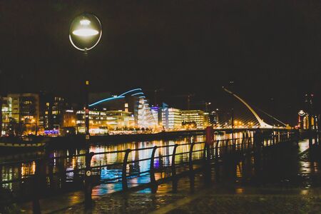 DUBLIN, IRELAND - November 9th, 2018: night time shot of the docklands buildings reflecting on the river Liffey in the centre of Dublin featuring the Samuel Beckett bridge and the convention centreのeditorial素材