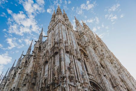 MILANO, ITALY - December 4th, 2018: Milan's famous gothic Duomo Cathedral with blue sky and fluffy cloudsのeditorial素材