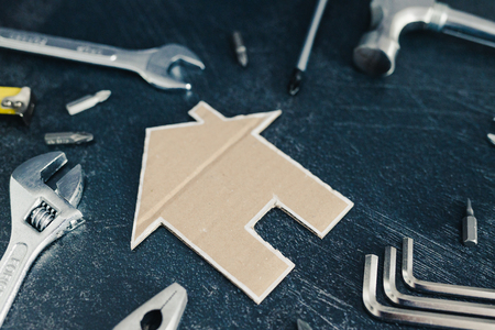 do it yourself and home renovation concept: set of DIY tools and little cardboard houseの写真素材